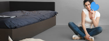 A woman in KSNS shoes, holding a heart-shaped sign in one hand.